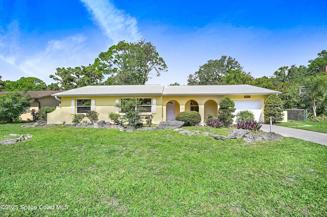 211 Naylor Dr, Melbourne, FL 32904 - ranch-style home featuring a garage, concrete driveway, stucco siding, and a front lawn