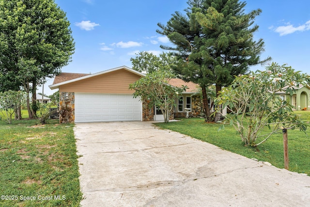 790 Alfonso Ave SE, Palm Bay, FL 32909 - view of front of property featuring concrete driveway, a garage, a front lawn, and stone siding