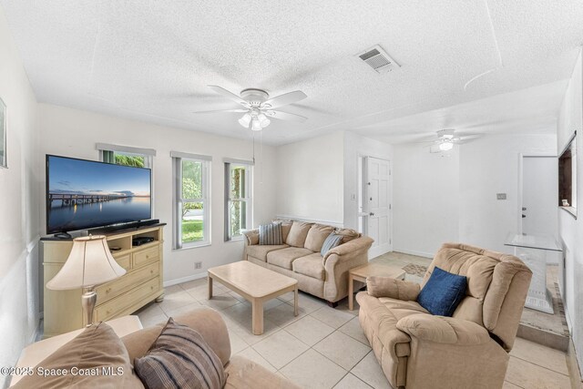 790 Alfonso Ave SE, Palm Bay, FL 32909 - living room with a ceiling fan, light tile patterned floors, baseboards, and a textured ceiling