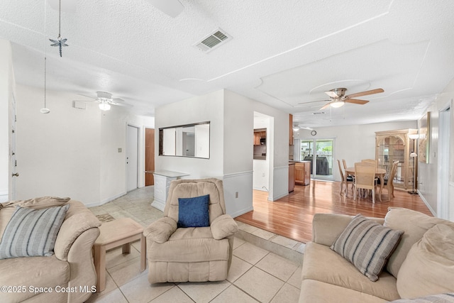 790 Alfonso Ave SE, Palm Bay, FL 32909 - living area featuring a ceiling fan, light tile patterned floors, a textured ceiling, and baseboards