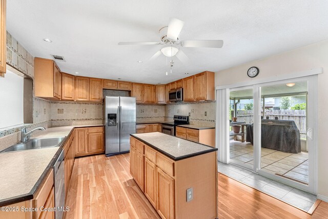 790 Alfonso Ave SE, Palm Bay, FL 32909 - kitchen with appliances with stainless steel finishes, light wood-style flooring, ceiling fan, and tasteful backsplash