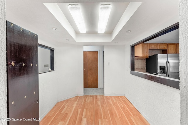 790 Alfonso Ave SE, Palm Bay, FL 32909 - hallway with a raised ceiling, light wood finished floors, and baseboards