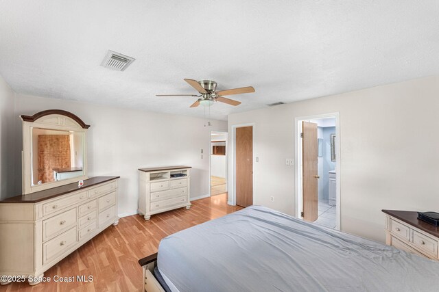 790 Alfonso Ave SE, Palm Bay, FL 32909 - bedroom featuring light wood-style floors, baseboards, ceiling fan, and ensuite bath
