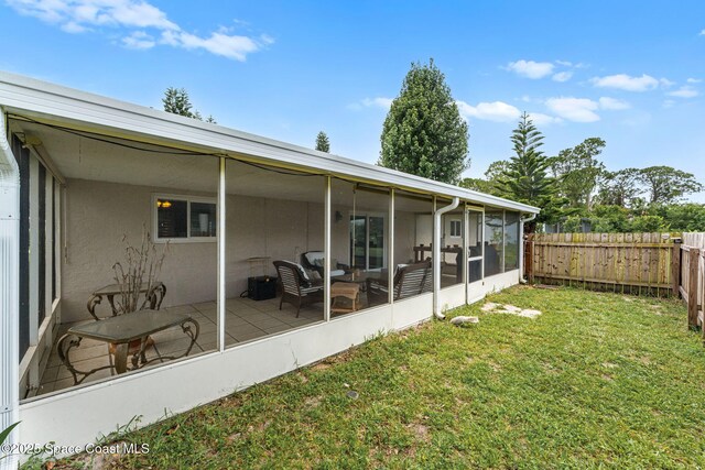 790 Alfonso Ave SE, Palm Bay, FL 32909 - rear view of house with a sunroom and stucco siding