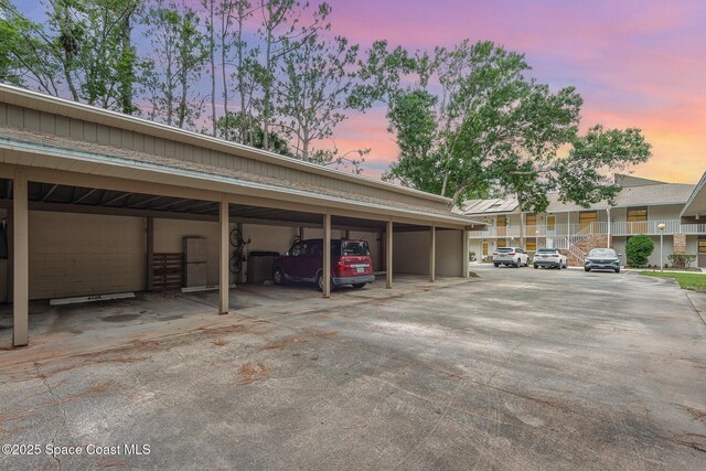 1600 Woodland Dr Unit 4105, Rockledge, FL 32955 - parking at dusk featuring covered parking
