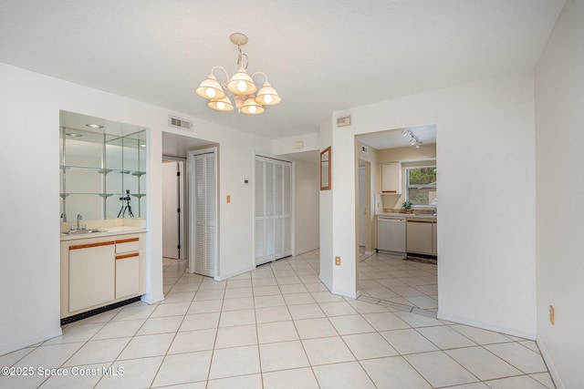 1600 Woodland Dr Unit 4105, Rockledge, FL 32955 - unfurnished bedroom featuring a sink, multiple closets, a chandelier, ensuite bathroom, and light tile patterned floors