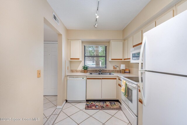 1600 Woodland Dr Unit 4105, Rockledge, FL 32955 - kitchen featuring white appliances, a sink, light countertops, track lighting, and light tile patterned flooring