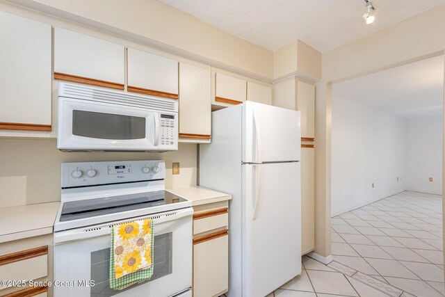 1600 Woodland Dr Unit 4105, Rockledge, FL 32955 - kitchen featuring white appliances, light countertops, and light tile patterned flooring