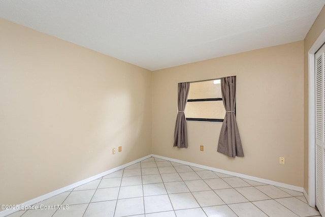 1600 Woodland Dr Unit 4105, Rockledge, FL 32955 - unfurnished bedroom with a closet, light tile patterned floors, and baseboards