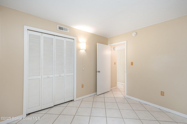1600 Woodland Dr Unit 4105, Rockledge, FL 32955 - unfurnished bedroom with a closet, baseboards, and light tile patterned floors