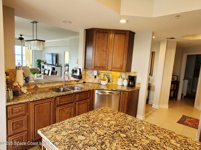 93 Delannoy Ave Unit 601, Cocoa, FL 32922 - kitchen with stainless steel dishwasher, decorative backsplash, brown cabinetry, light stone countertops, and ceiling fan