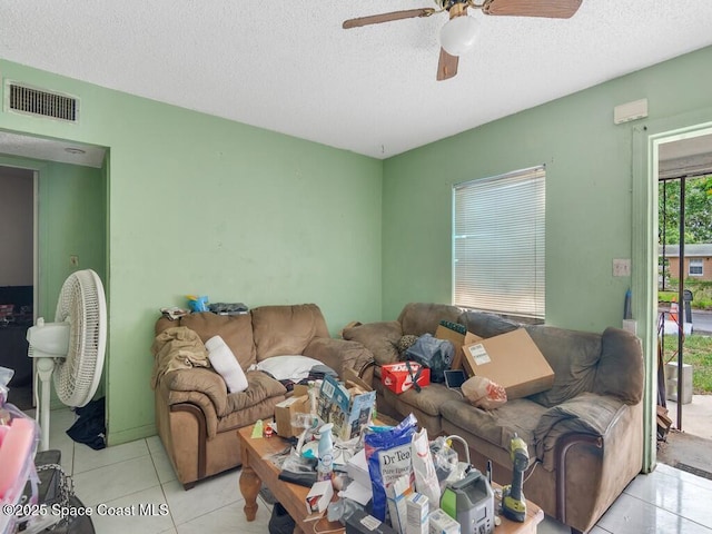308 N 18th Ct, Ft Pierce, FL 34950 - living room with a textured ceiling, a ceiling fan, and tile patterned floors