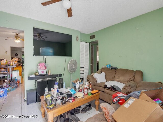 308 N 18th Ct, Ft Pierce, FL 34950 - living room featuring a ceiling fan, tile patterned floors, and a textured ceiling