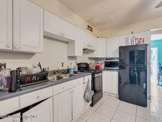 308 N 18th Ct, Ft Pierce, FL 34950 - kitchen featuring black appliances, a sink, a textured ceiling, and white cabinets