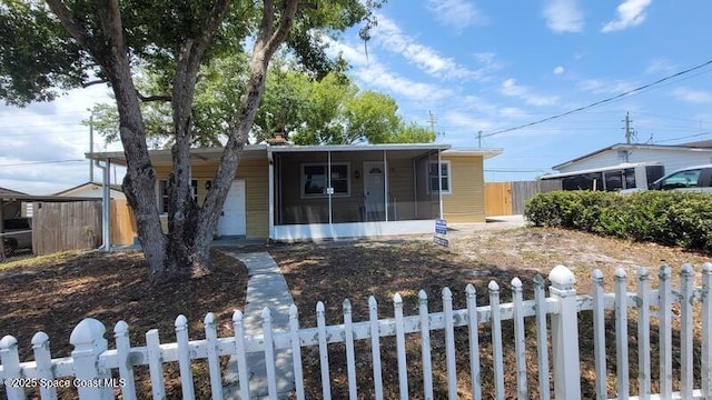 1666 Terrace St, Cocoa, FL 32922 - ranch-style home with a fenced front yard and a sunroom