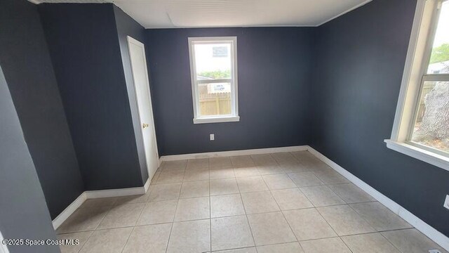 1666 Terrace St, Cocoa, FL 32922 - empty room with plenty of natural light, tile patterned flooring, and baseboards