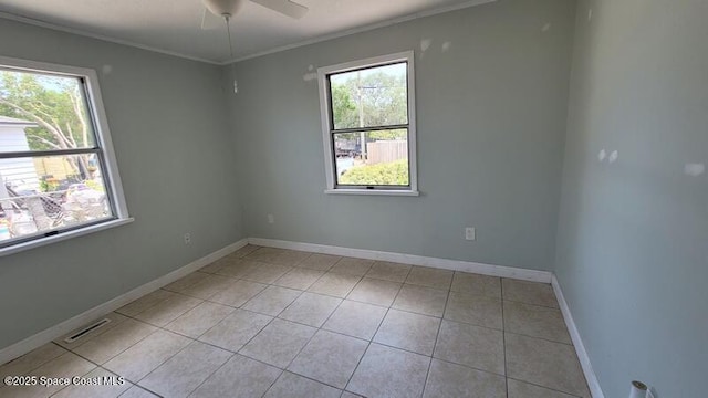 1666 Terrace St, Cocoa, FL 32922 - empty room featuring plenty of natural light, crown molding, ceiling fan, and light tile patterned floors