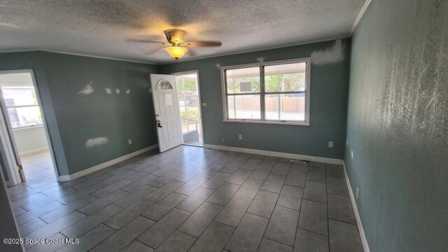 1666 Terrace St, Cocoa, FL 32922 - spare room featuring a textured ceiling, crown molding, a ceiling fan, and baseboards