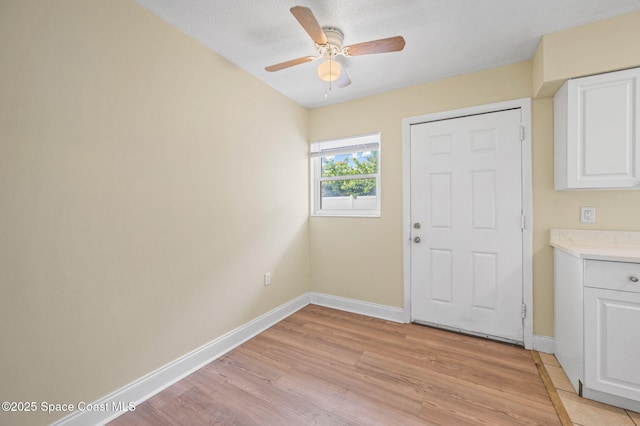 714 Catalina Rd Unit 15, Cocoa Beach, FL 32931 - entrance foyer with baseboards, light wood-style floors, and a ceiling fan