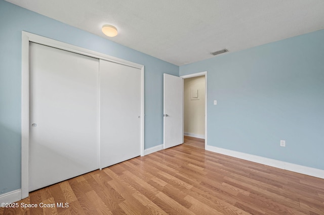 714 Catalina Rd Unit 15, Cocoa Beach, FL 32931 - unfurnished bedroom featuring wood finished floors, a closet, and baseboards