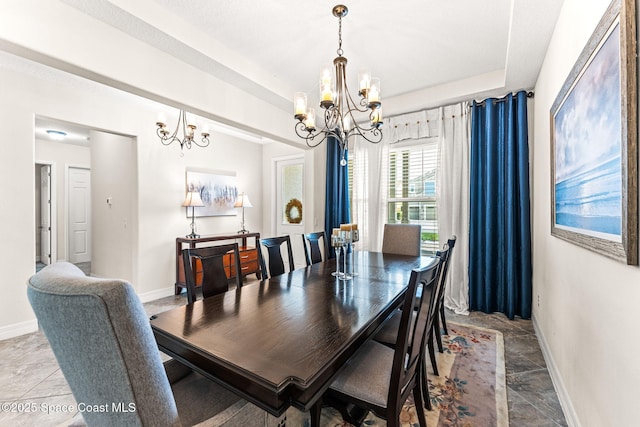 14880 Ellingsworth Ln, Winter Garden, FL 34787 - dining area featuring a chandelier, baseboards, and stone finish floors