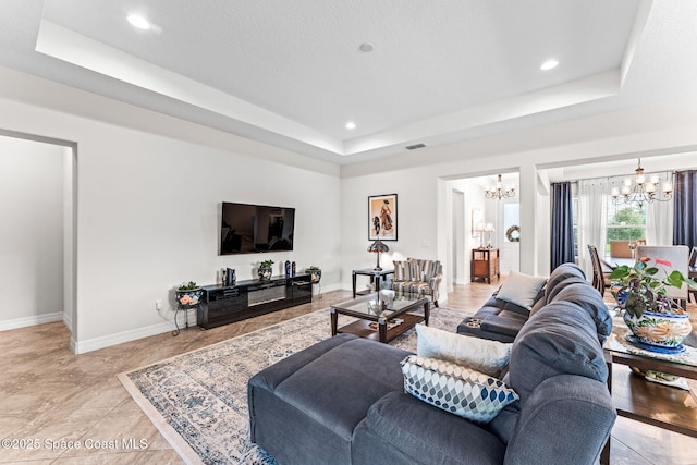 14880 Ellingsworth Ln, Winter Garden, FL 34787 - living area featuring a chandelier, a raised ceiling, baseboards, and recessed lighting