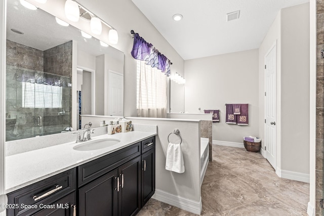 14880 Ellingsworth Ln, Winter Garden, FL 34787 - bathroom featuring a shower stall, vanity, a bath, and baseboards
