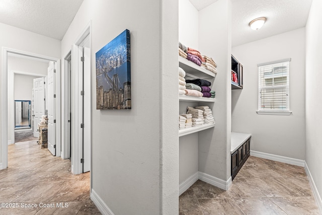 14880 Ellingsworth Ln, Winter Garden, FL 34787 - hall featuring a textured ceiling and baseboards