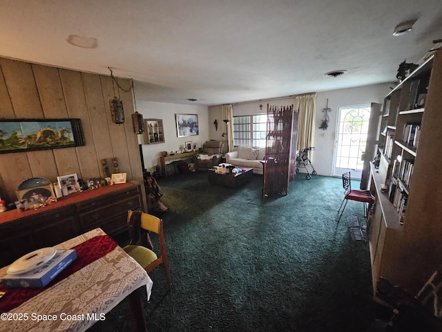 2240 Sea Ave, Indialantic, FL 32903 - living area featuring carpet and wooden walls