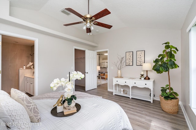 1102 Bainbury Ln, Melbourne, FL 32904 - bedroom featuring vaulted ceiling, wood finished floors, ensuite bathroom, a closet, and a spacious closet