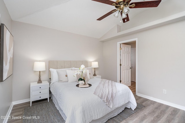 1102 Bainbury Ln, Melbourne, FL 32904 - bedroom with vaulted ceiling, wood finished floors, and a ceiling fan