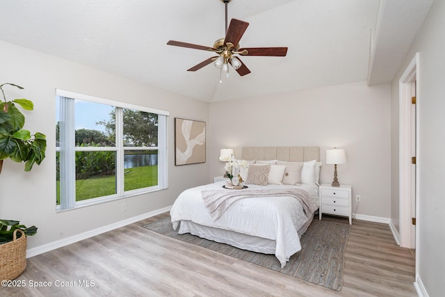1102 Bainbury Ln, Melbourne, FL 32904 - bedroom featuring wood finished floors, vaulted ceiling, and a ceiling fan
