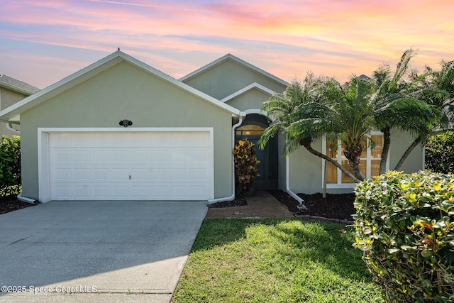 1102 Bainbury Ln, Melbourne, FL 32904 - ranch-style home with driveway, a garage, and stucco siding