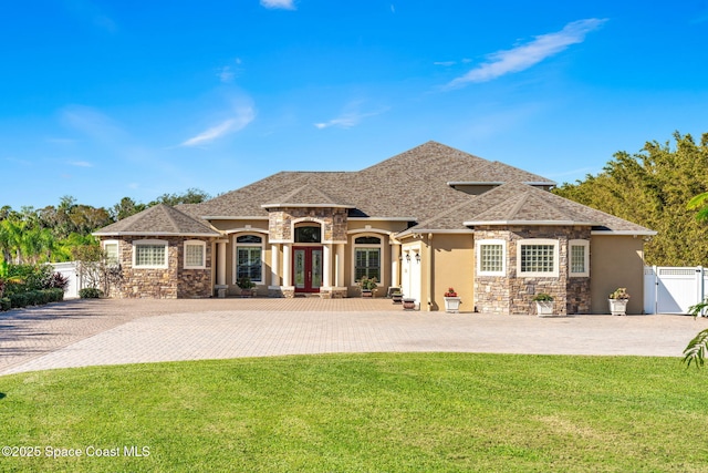 4022 Tradewinds Trl, Merritt Island, FL 32953 - french country inspired facade featuring stone siding, french doors, and stucco siding
