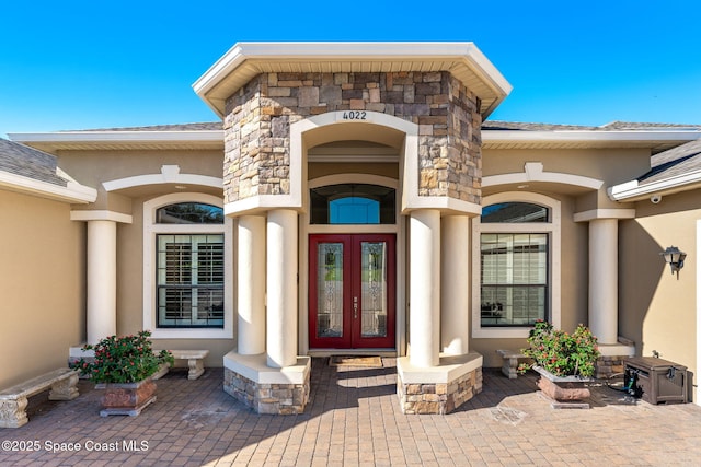 4022 Tradewinds Trl, Merritt Island, FL 32953 - doorway to property featuring french doors, stucco siding, and stone siding