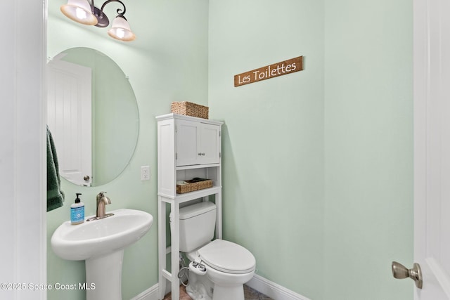 4022 Tradewinds Trl, Merritt Island, FL 32953 - bathroom featuring toilet and baseboards