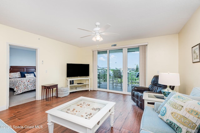 8700 Ridgewood Ave Unit Ph2B, Cape Canaveral, FL 32920 - living area featuring wood finished floors and a ceiling fan