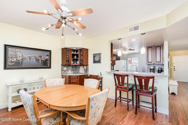 8700 Ridgewood Ave Unit Ph2B, Cape Canaveral, FL 32920 - dining area featuring a ceiling fan, wood finished floors, and baseboards