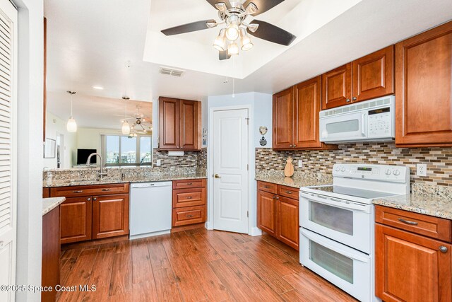8700 Ridgewood Ave Unit Ph2B, Cape Canaveral, FL 32920 - kitchen with white appliances, ceiling fan, brown cabinets, and recessed lighting