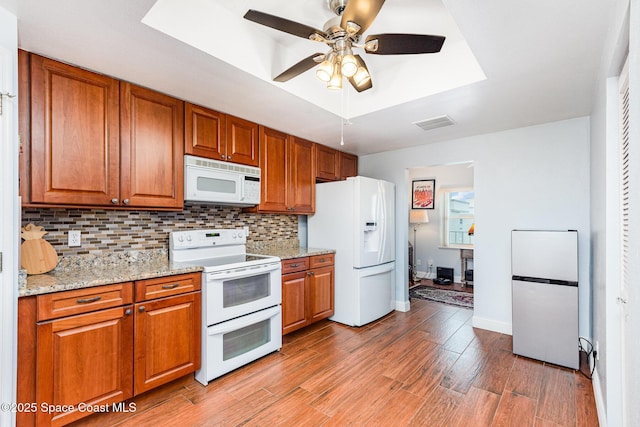 8700 Ridgewood Ave Unit Ph2B, Cape Canaveral, FL 32920 - kitchen featuring white appliances, brown cabinets, tasteful backsplash, and a ceiling fan