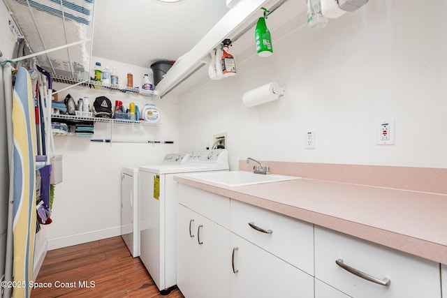 8700 Ridgewood Ave Unit Ph2B, Cape Canaveral, FL 32920 - washroom featuring separate washer and dryer, wood finished floors, baseboards, and cabinet space