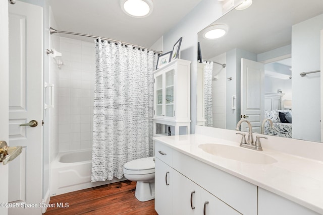 8700 Ridgewood Ave Unit Ph2B, Cape Canaveral, FL 32920 - full bath featuring wood finished floors, toilet, ensuite bathroom, vanity, and shower / bath combination with curtain