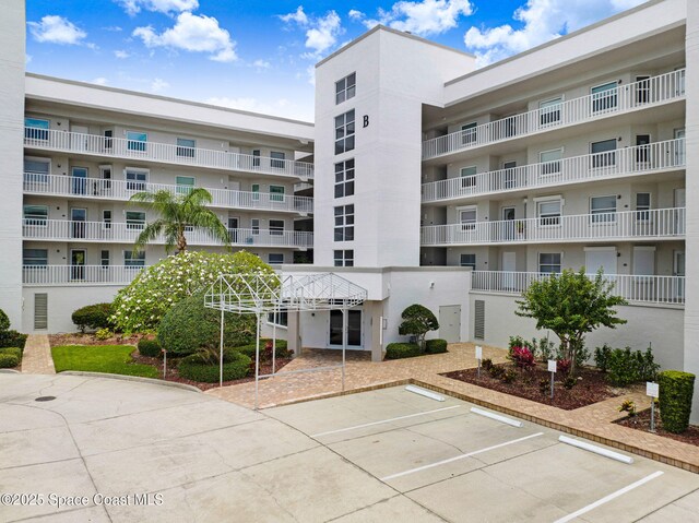 8700 Ridgewood Ave Unit Ph2B, Cape Canaveral, FL 32920 - view of apartment building / complex with uncovered parking