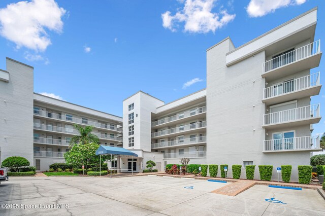 8700 Ridgewood Ave Unit Ph2B, Cape Canaveral, FL 32920 - view of apartment building / complex featuring uncovered parking