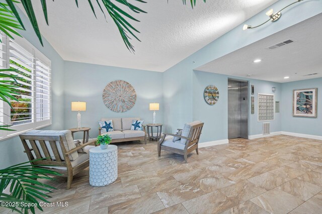 8700 Ridgewood Ave Unit Ph2B, Cape Canaveral, FL 32920 - living room with elevator and a textured ceiling