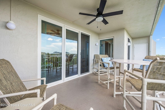8700 Ridgewood Ave Unit Ph2B, Cape Canaveral, FL 32920 - balcony with ceiling fan and outdoor dining area