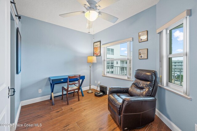 8700 Ridgewood Ave Unit Ph2B, Cape Canaveral, FL 32920 - living area featuring wood finished floors and ceiling fan