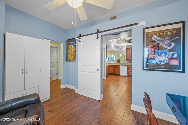 8700 Ridgewood Ave Unit Ph2B, Cape Canaveral, FL 32920 - office with a ceiling fan, a barn door, and dark wood-style floors