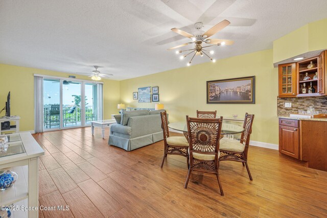 8700 Ridgewood Ave Unit Ph2B, Cape Canaveral, FL 32920 - dining room with light wood-type flooring and a ceiling fan