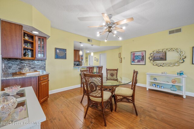 8700 Ridgewood Ave Unit Ph2B, Cape Canaveral, FL 32920 - dining space featuring light wood finished floors and a ceiling fan